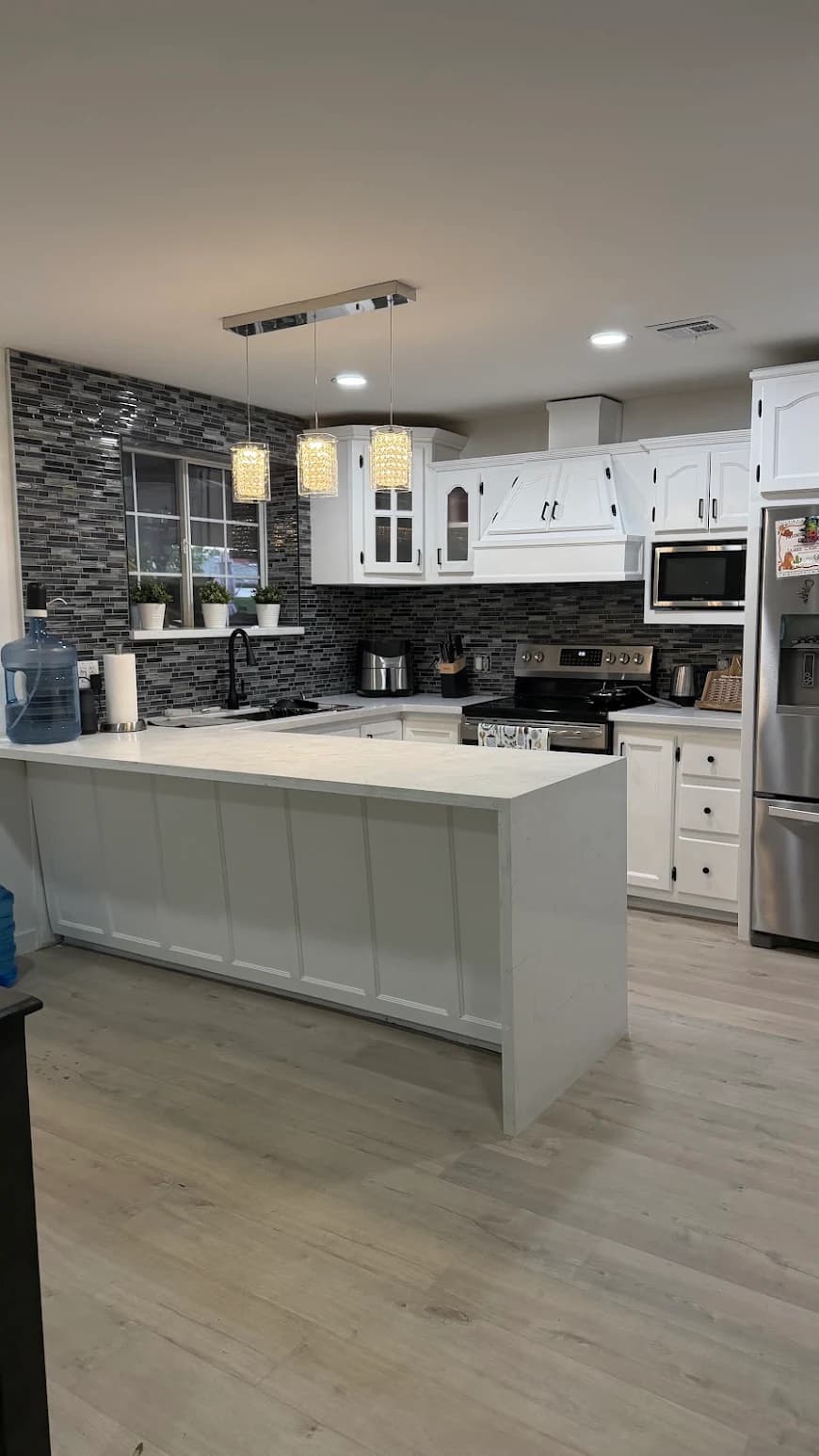 Modern kitchen with a white marble waterfall island